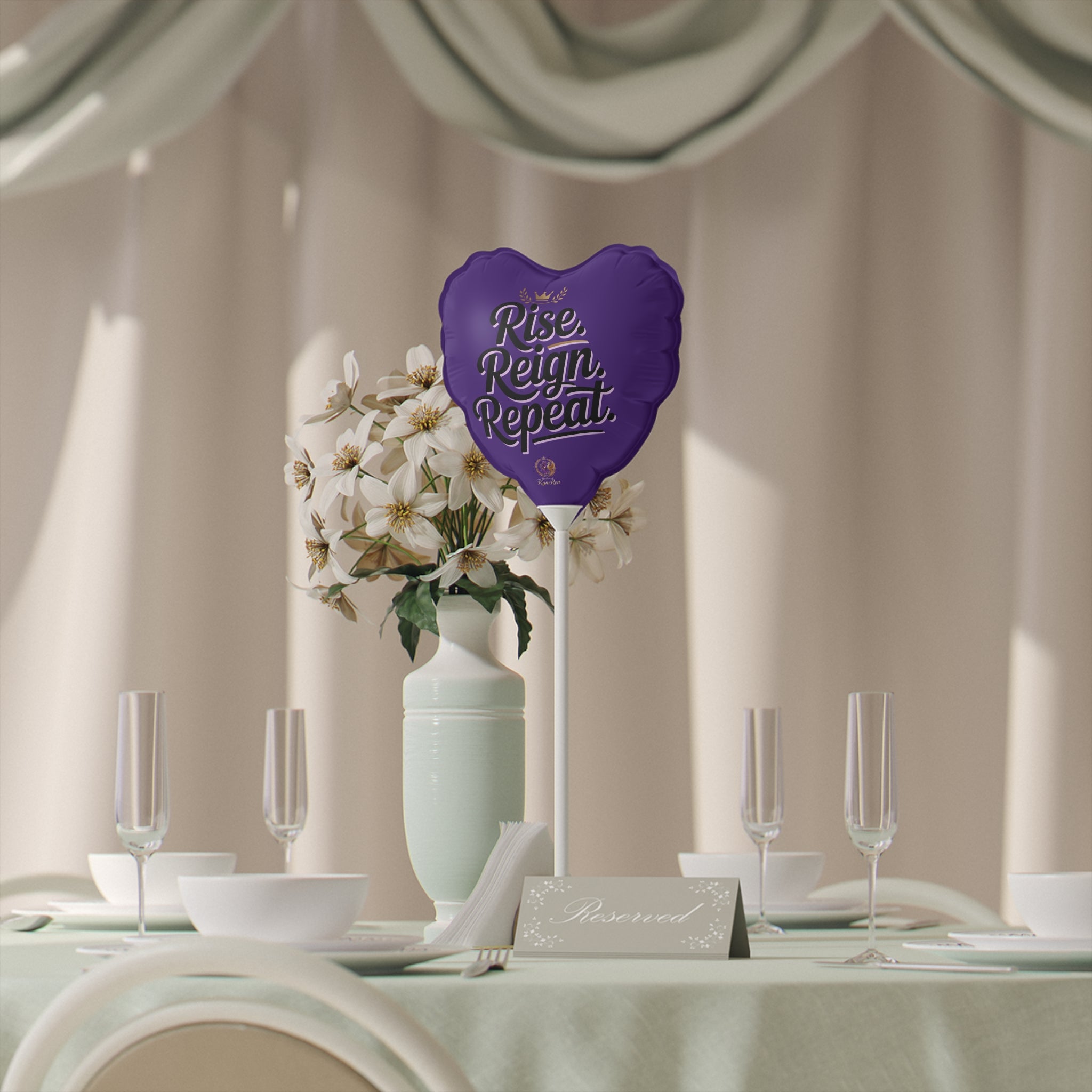 Decorative table setting with a purple heart-shaped sign and floral arrangement.