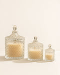 Three glass jars with textured lids on a light beige background