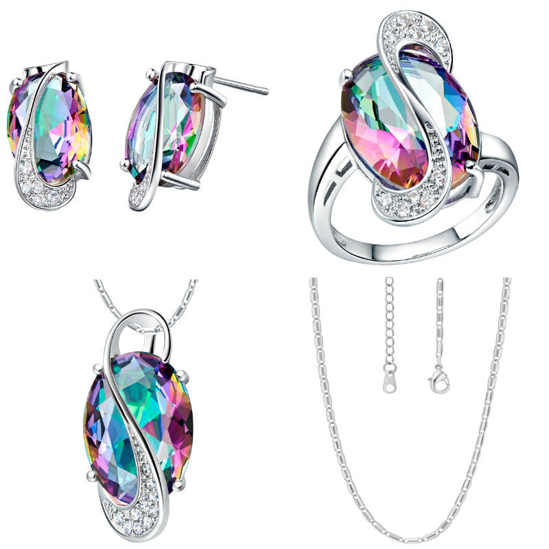 Jewelry set with rainbow-colored gemstones on a white background