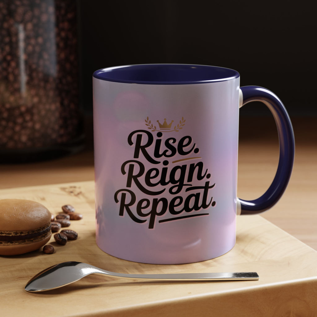 Mug with 'Rise. Reign. Repeat.' text on a wooden surface with coffee beans and a spoon.