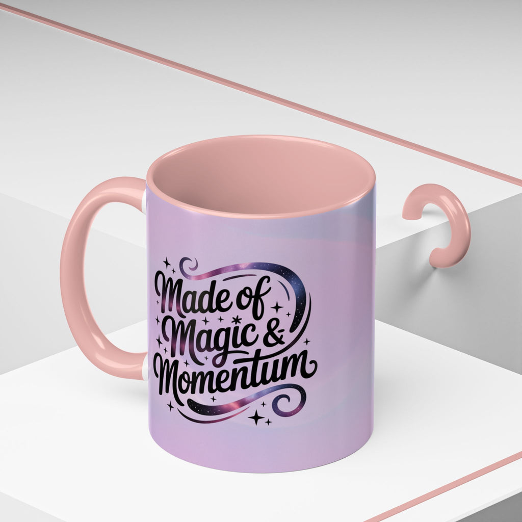 Pink mug with 'Made of Magic & Momentum' text on a white background