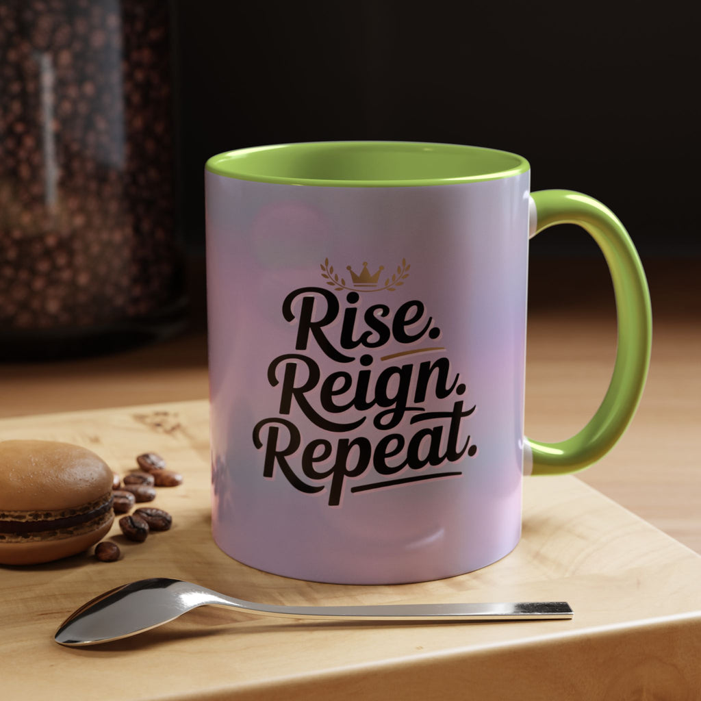 Mug with 'Rise. Reign. Repeat.' text on a wooden surface with coffee beans and a spoon.