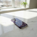 Phone case with gold designs on a marble surface