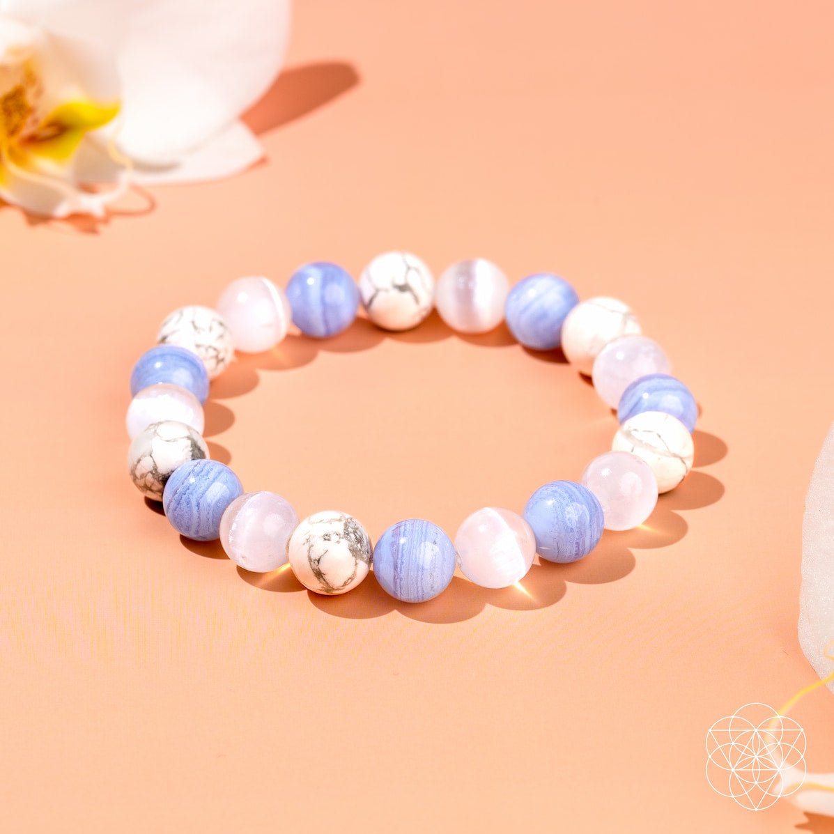 Beaded bracelet with blue and white beads on a peach background