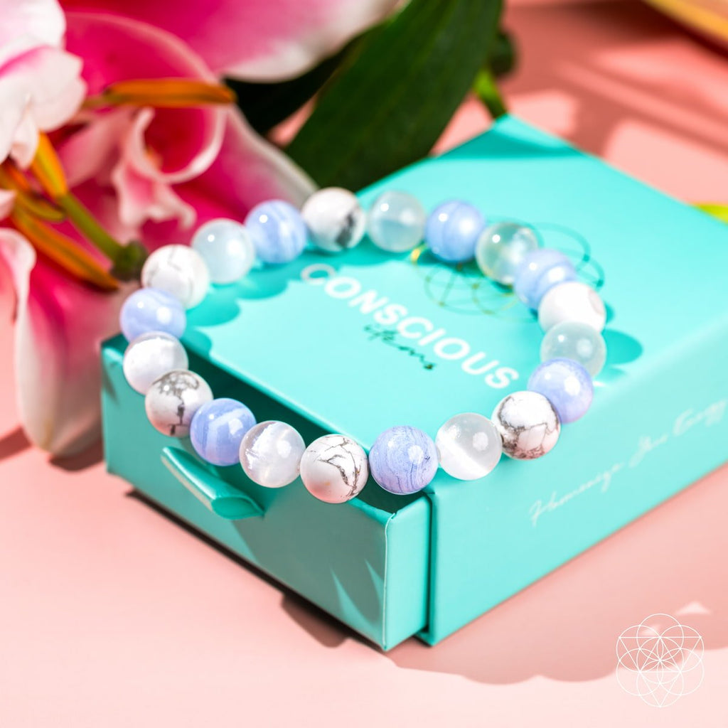 Beaded bracelet on a turquoise box with pink flowers in the background